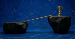 The plateau of latent potential symbolized through two black rocks with a golden bridge in between.