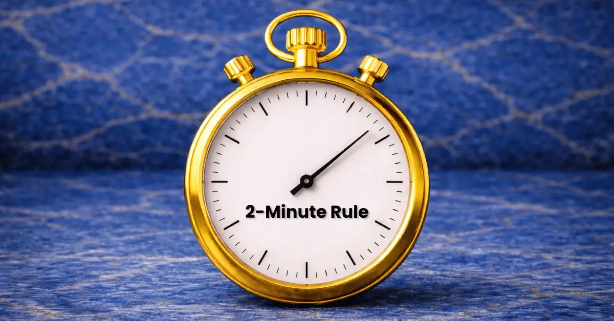 Gold stopwatch stopped at two minutes on a deep blue lapis lazuli surface, symbolizing the 2-Minute Rule for overcoming procrastination