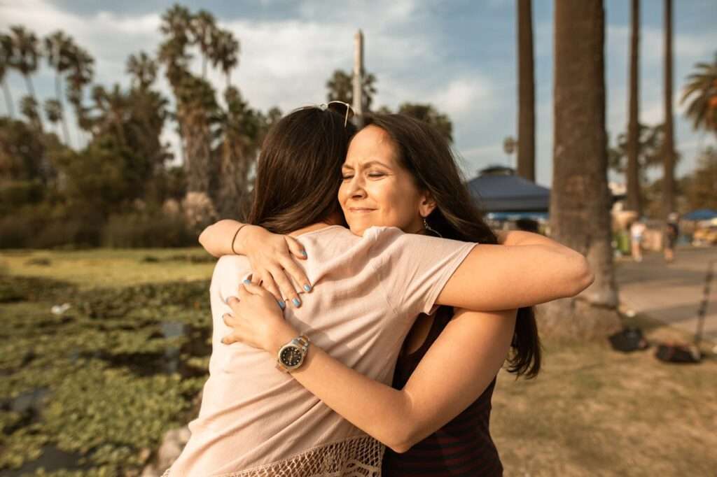 two women giving each other a hug after forgiving